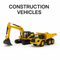 Diecast construction vehicles – yellow excavator and dump truck model on white background