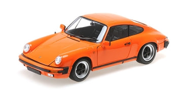 Orange 1:18 scale diecast Porsche model car with black interior and detailed wheels