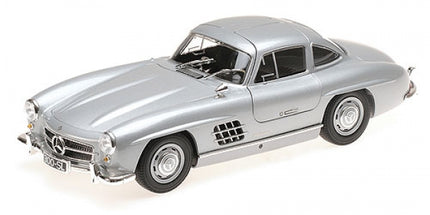 Silver diecast model car, classic coupe design, displayed on white background