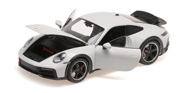 1:18 scale white Porsche diecast model car with open doors and hood