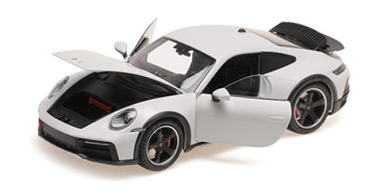 1:18 scale white diecast Porsche model car with open doors and hood, detailed interior