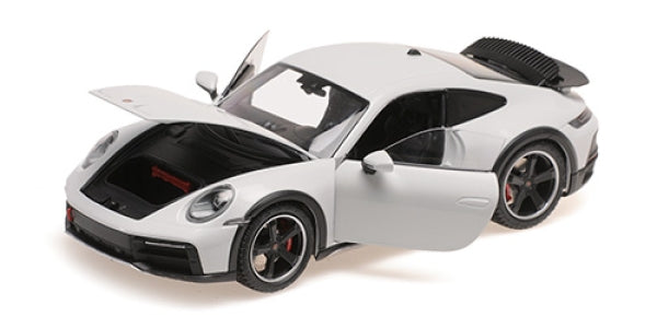 1:18 scale white diecast Porsche model car with open doors and hood, detailed interior