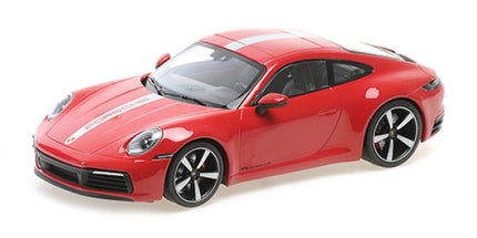 Red Porsche 911 diecast model car 1:18 scale with white racing stripes on white background