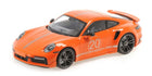 Orange 1:18 scale Porsche diecast model car with racing stripes and number 20 detailing