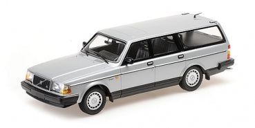 Silver 1:18 scale diecast model of classic station wagon car on white background
