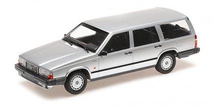 Silver diecast model station wagon car in 1:18 scale, side angle view on white background