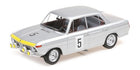 Silver diecast model race car with number 5, yellow accents, and rally headlights, 1:18 scale.