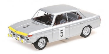 Diecast silver BMW model car in 1:18 scale with rally decals and front fog lights