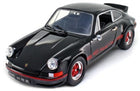 Black diecast Porsche model car with red trim details, 1:18 scale collectible.