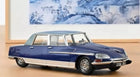 1:18 scale blue diecast model classic car with chrome accents on tabletop display