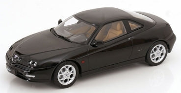 1:18 scale black diecast model car coupe with silver wheels and tan interior