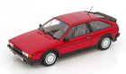 Red 1:18 scale diecast model car with black trim and rear spoiler on white background