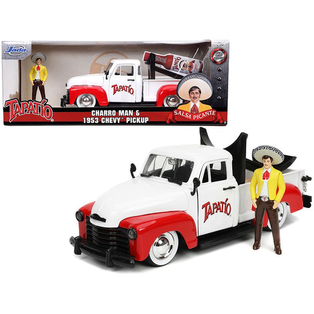 https://cdn.shopify.com/s/files/1/0504/9925/6496/files/1953-chevrolet-pickup-truck-white-and-red-with-charro-man-diecast-figurine-tapatio-124-diecast-model-car-by-jada-439973.jpg?v=1748419485