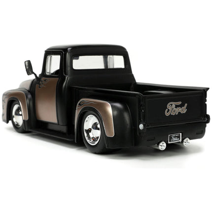https://cdn.shopify.com/s/files/1/0504/9925/6496/files/1956-ford-f-100-pickup-truck-matt-black-and-champagne-with-flames-with-extra-wheels-just-trucks-series-124-diecast-model-car-by-jada-667703.jpg?v=1748419221