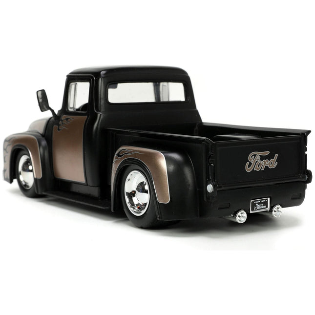 https://cdn.shopify.com/s/files/1/0504/9925/6496/files/1956-ford-f-100-pickup-truck-matt-black-and-champagne-with-flames-with-extra-wheels-just-trucks-series-124-diecast-model-car-by-jada-667703.jpg?v=1748419221