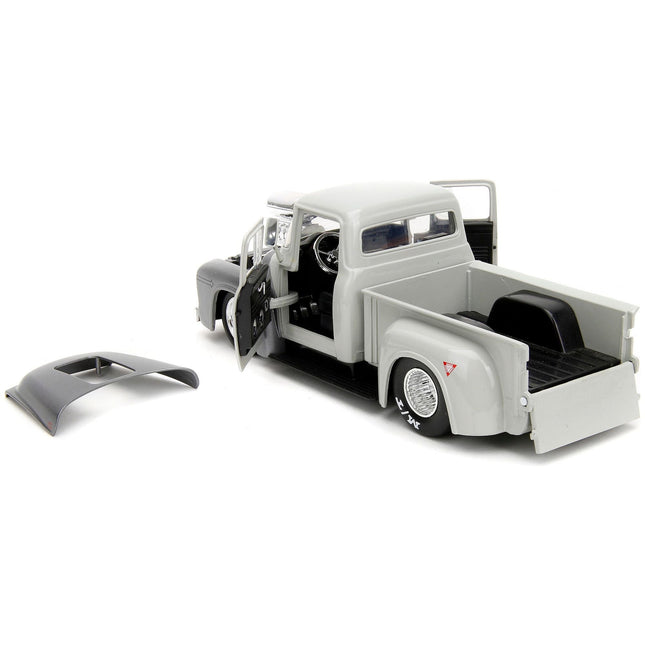 https://cdn.shopify.com/s/files/1/0504/9925/6496/files/1956-ford-f-100-pickup-truck-tan-and-gray-metallic-and-guile-diecast-figure-street-fighter-video-game-anime-hollywood-rides-series-124-diecast-model-car-by-jada-403637.jpg?v=1748419128