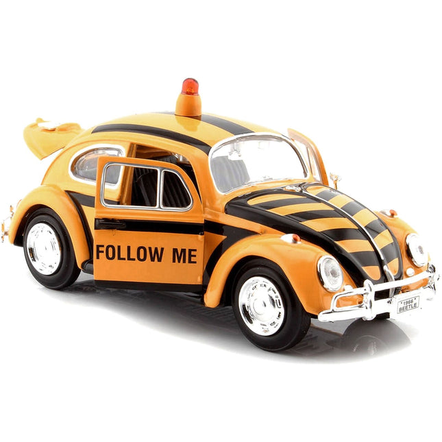 https://cdn.shopify.com/s/files/1/0504/9925/6496/files/1966-volkswagen-beetle-follow-me-airport-safety-vehicle-yellow-with-black-stripes-124-diecast-model-car-by-motormax-234899.jpg?v=1748418079