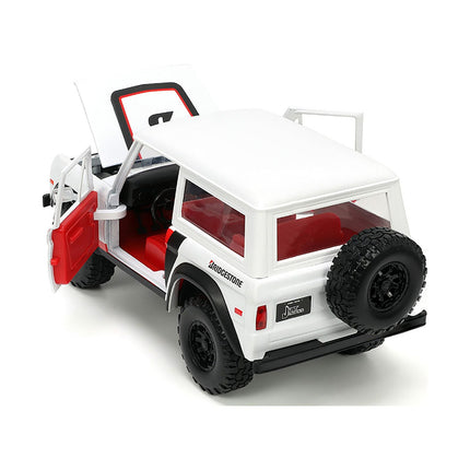 https://cdn.shopify.com/s/files/1/0504/9925/6496/files/1973-ford-bronco-008-white-with-red-and-black-stripes-and-red-interior-with-extra-wheels-just-trucks-series-124-diecast-model-car-by-jada-235817.jpg?v=1748419128