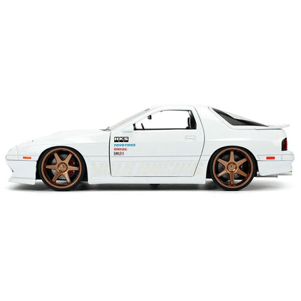 https://cdn.shopify.com/s/files/1/0504/9925/6496/files/1985-mazda-rx-7-white-jdm-tuners-series-124-diecast-model-car-by-jada-449640.jpg?v=1756087217