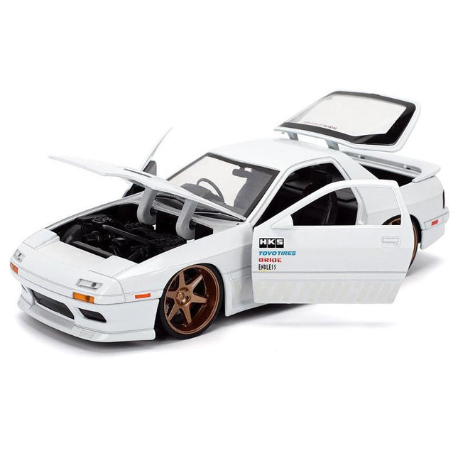 https://cdn.shopify.com/s/files/1/0504/9925/6496/files/1985-mazda-rx-7-white-jdm-tuners-series-124-diecast-model-car-by-jada-506921.jpg?v=1756087217