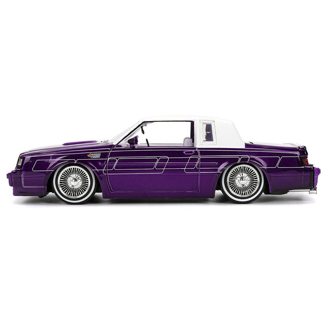 https://cdn.shopify.com/s/files/1/0504/9925/6496/files/1987-buick-grand-national-candy-purple-with-graphics-and-white-top-and-interior-bigtime-muscle-series-124-diecast-model-car-by-jada-636824.jpg?v=1756086814