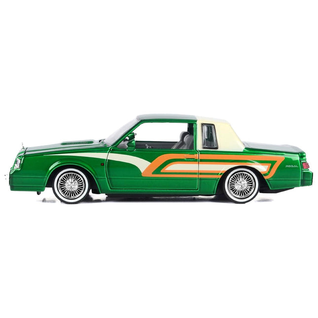 https://cdn.shopify.com/s/files/1/0504/9925/6496/files/1987-buick-regal-38-sfi-turbo-green-metallic-and-cream-with-graphics-get-low-series-124-diecast-model-car-by-motormax-381147.jpg?v=1748405774