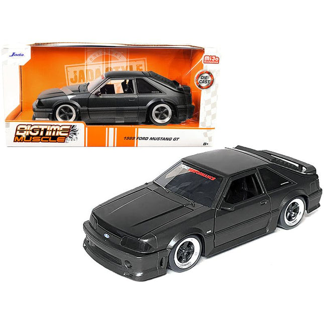 https://cdn.shopify.com/s/files/1/0504/9925/6496/files/1989-ford-mustang-gt-50-matt-black-metallic-with-matt-black-hood-bigtime-muscle-series-124-series-diecast-model-car-by-jada-726981.jpg?v=1748419223