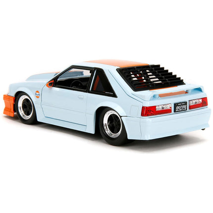 https://cdn.shopify.com/s/files/1/0504/9925/6496/files/1989-ford-mustang-gt-gulf-oil-light-blue-with-orange-stripe-bigtime-muscle-series-124-diecast-model-car-by-jada-980672.jpg?v=1748405015