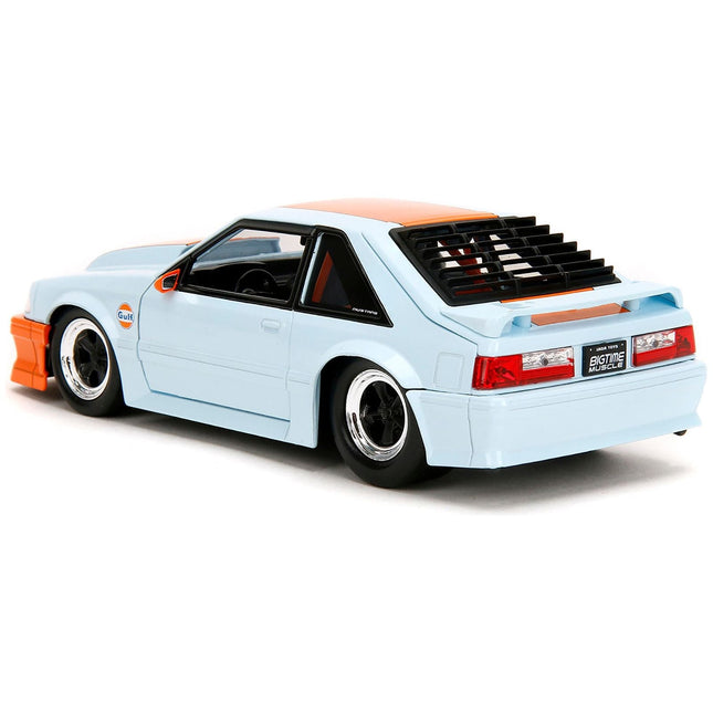 https://cdn.shopify.com/s/files/1/0504/9925/6496/files/1989-ford-mustang-gt-gulf-oil-light-blue-with-orange-stripe-bigtime-muscle-series-124-diecast-model-car-by-jada-980672.jpg?v=1748405015