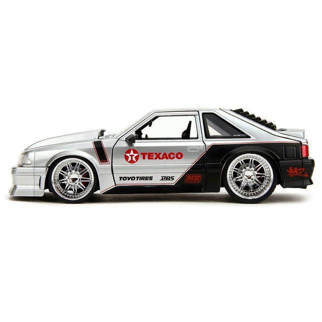 https://cdn.shopify.com/s/files/1/0504/9925/6496/files/1989-ford-mustang-gt-texaco-silver-metallic-and-matt-black-bigtime-muscle-series-124-diecast-model-car-by-jada-858697.jpg?v=1756087114