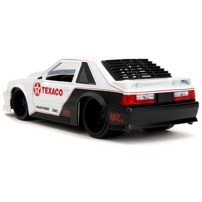https://cdn.shopify.com/s/files/1/0504/9925/6496/files/1989-ford-mustang-gt-texaco-white-and-matt-black-with-graphics-bigtime-muscle-series-124-diecast-model-car-by-jada-267289.jpg?v=1748419011