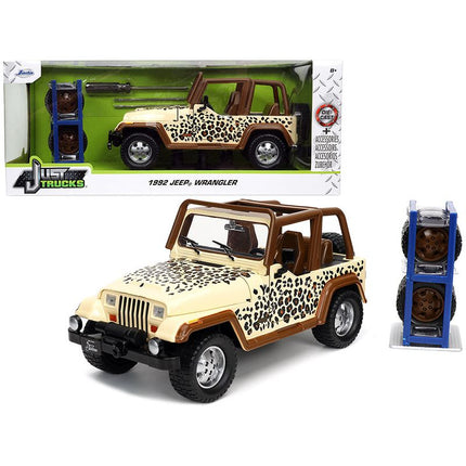 https://cdn.shopify.com/s/files/1/0504/9925/6496/files/1992-jeep-wrangler-tan-and-brown-with-graphics-and-extra-wheels-just-trucks-series-124-diecast-model-car-by-jada-890215.jpg?v=1748419235