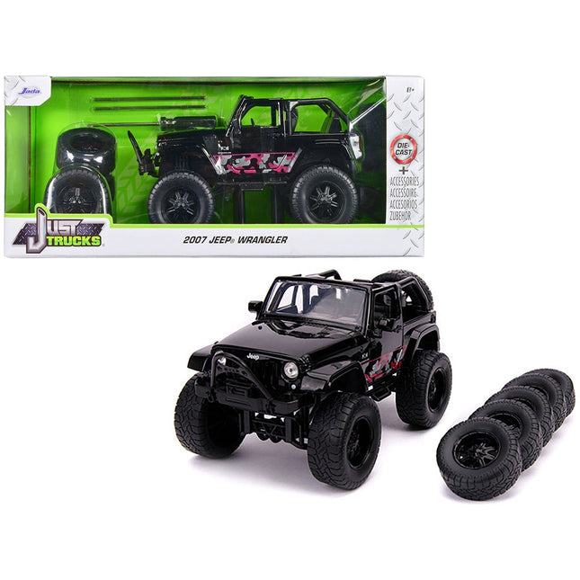 https://cdn.shopify.com/s/files/1/0504/9925/6496/files/2007-jeep-wrangler-black-with-extra-wheels-just-trucks-series-124-diecast-model-car-by-jada-591676.jpg?v=1748419009