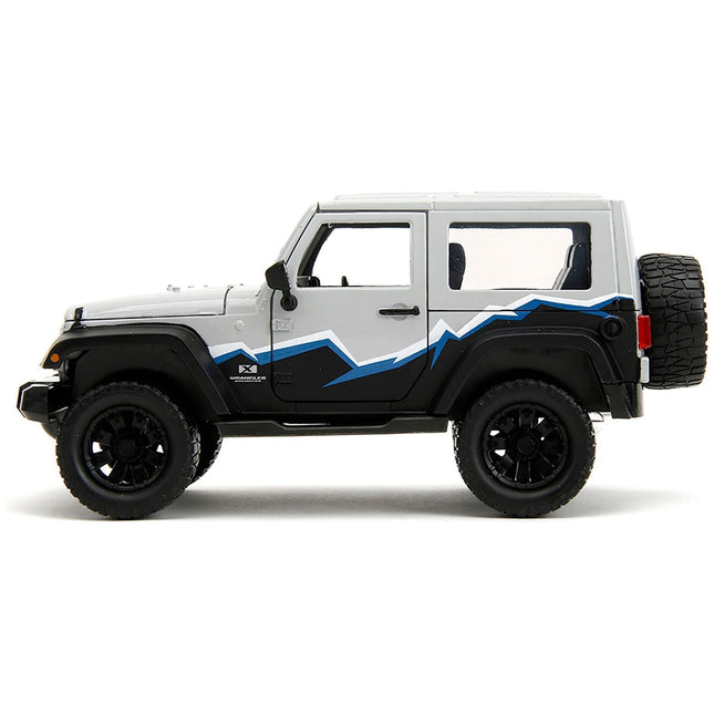 https://cdn.shopify.com/s/files/1/0504/9925/6496/files/2007-jeep-wrangler-gray-and-black-with-blue-and-white-stripes-with-extra-wheels-just-trucks-series-124-diecast-model-car-by-jada-776235.jpg?v=1748419129