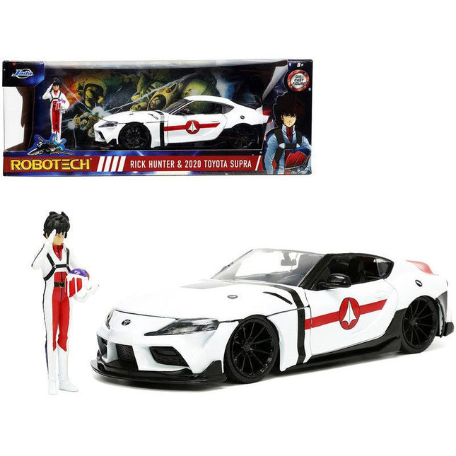 https://cdn.shopify.com/s/files/1/0504/9925/6496/files/2020-toyota-supra-white-and-rick-hunter-diecast-figurine-robotech-hollywood-rides-series-124-diecast-model-car-by-jada-982421.jpg?v=1756087350