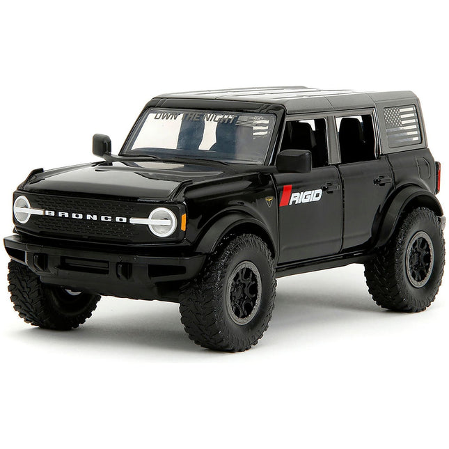 https://cdn.shopify.com/s/files/1/0504/9925/6496/files/2021-ford-bronco-badlands-black-rigid-with-extra-wheels-just-trucks-series-124-diecast-model-car-by-jada-458946.jpg?v=1748405105