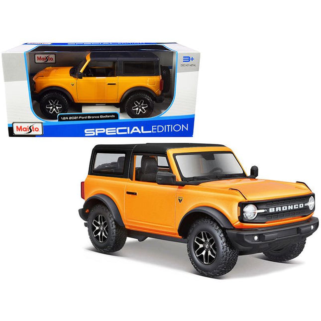 https://cdn.shopify.com/s/files/1/0504/9925/6496/files/2021-ford-bronco-badlands-orange-metallic-with-black-top-special-edition-124-diecast-model-car-by-maisto-661784.jpg?v=1748418505