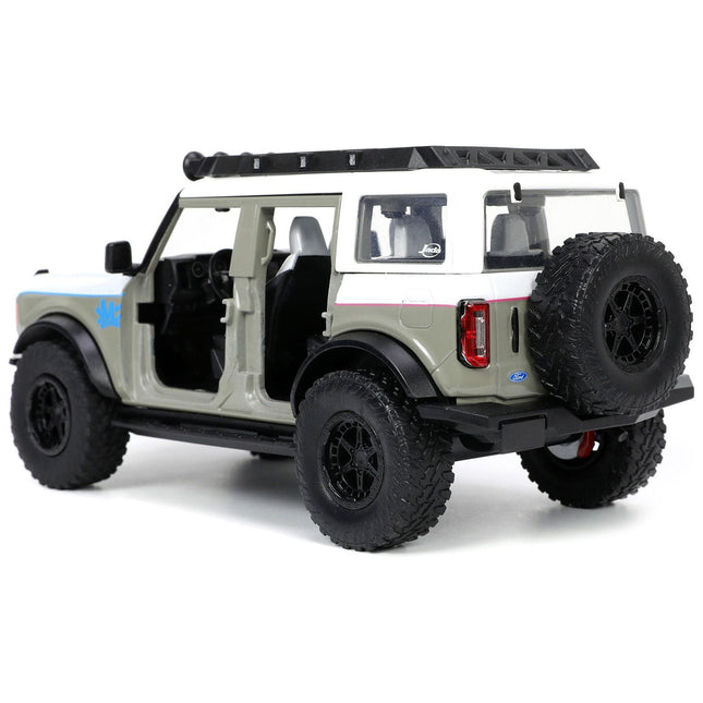 https://cdn.shopify.com/s/files/1/0504/9925/6496/files/2021-ford-bronco-gray-and-white-with-matt-black-hood-with-roof-rack-m2-motoring-just-trucks-series-124-diecast-model-car-by-jada-171941.jpg?v=1748419130
