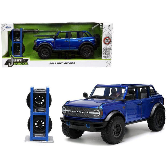 https://cdn.shopify.com/s/files/1/0504/9925/6496/files/2021-ford-bronco-open-top-candy-blue-metallic-with-extra-wheels-just-trucks-series-124-diecast-model-car-by-jada-663378.jpg?v=1756087218