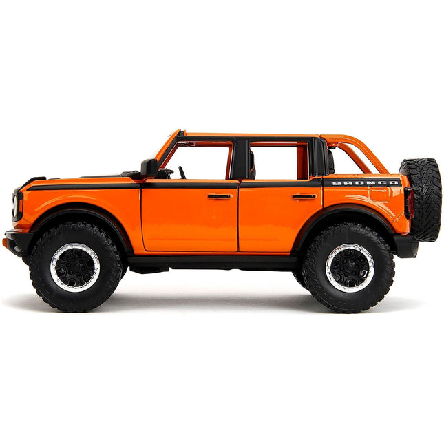 https://cdn.shopify.com/s/files/1/0504/9925/6496/files/2021-ford-bronco-open-top-orange-with-black-stripes-and-hood-with-extra-wheels-just-trucks-series-124-diecast-model-car-by-jada-818483.jpg?v=1748403838
