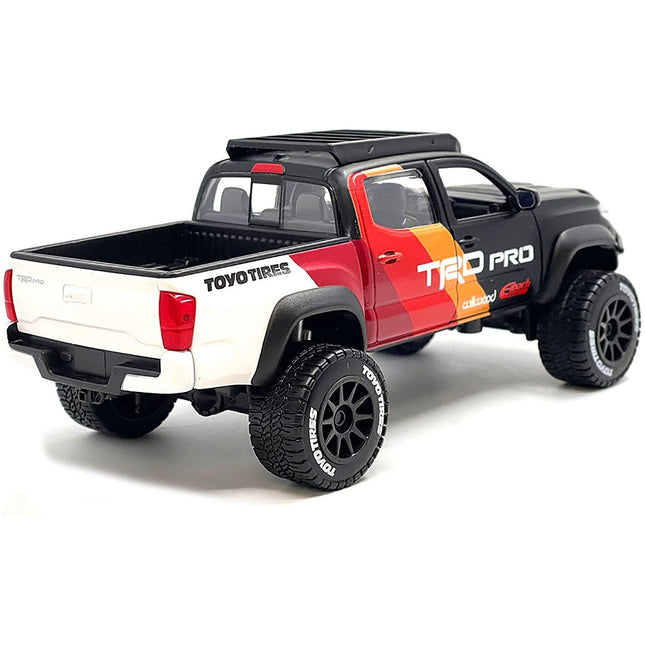 https://cdn.shopify.com/s/files/1/0504/9925/6496/files/2023-toyota-tacoma-trd-pro-off-road-pickup-truck-matt-black-with-graphics-and-roofrack-maisto-design-series-127-diecast-model-car-by-maisto-369858.jpg?v=1748403381