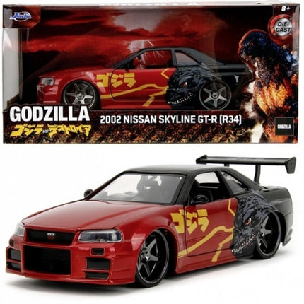 Diecast 2002 Nissan Skyline GT-R R34 model car with Godzilla graphics, red and black livery.