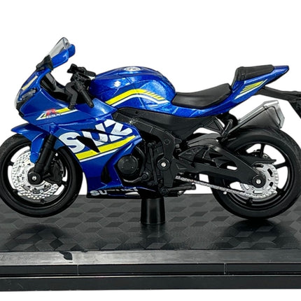 Blue Suzuki diecast model motorcycle 1:18 scale on display stand, side view