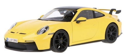 Yellow diecast model car 1:18 scale, sports coupe with black wheels and rear wing