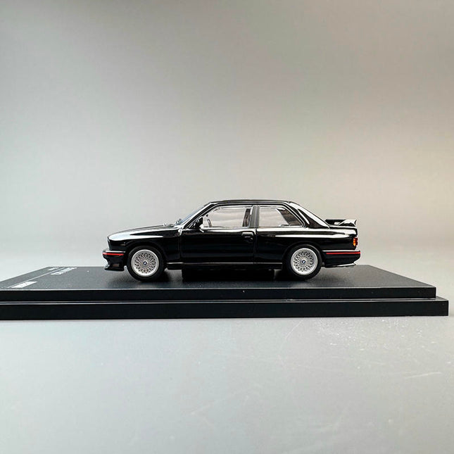 Almost Real BMW M3 (E30) Black 1:64 Diecast Model Car - studio product photo of the scale model