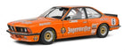 Orange BMW diecast model car 1:18 scale with racing livery and gold wheels
