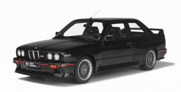 Black 1:18 scale BMW model car with detailed rims and rear spoiler, diecast collectible.
