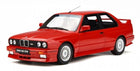 Red BMW M3 E30 diecast model car in 1:18 scale, detailed exterior, on white background