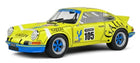 Yellow 1:18 scale diecast model Porsche race car with blue wheels and number 105 decals.