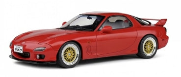 1:18 scale red Mazda RX-7 diecast model car with gold wheels, side view